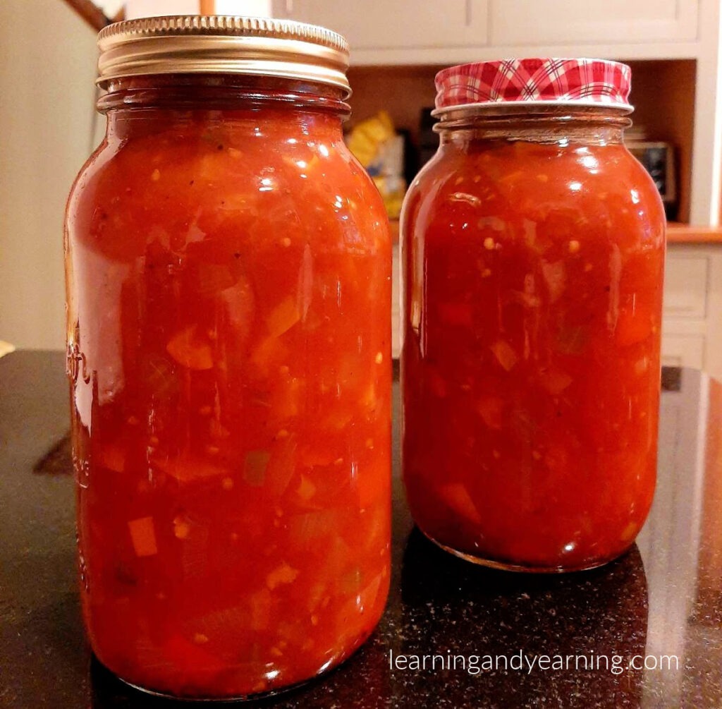 Jars of homemade chili sauce sweetened with maple syrup